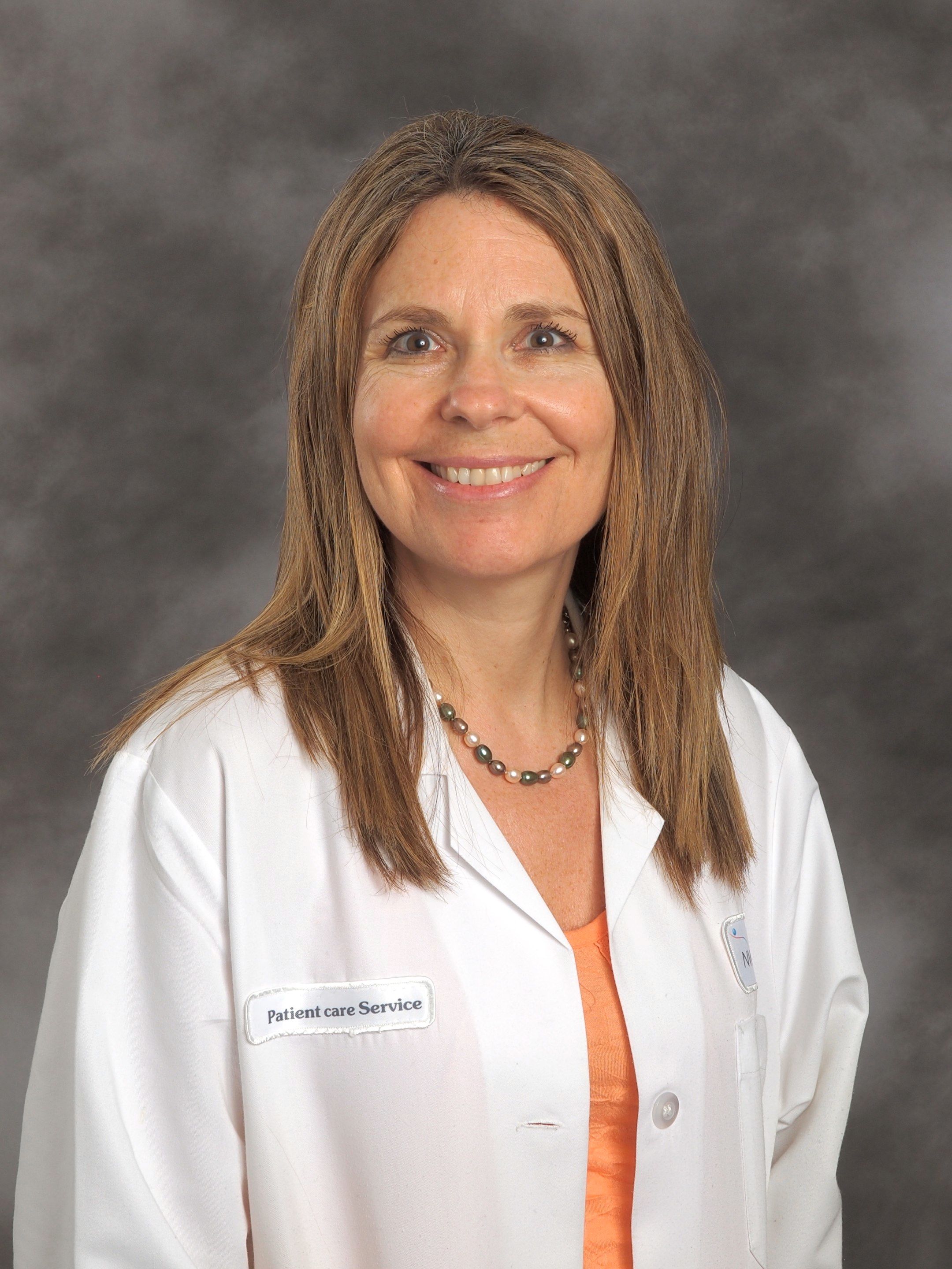 Marla Koroly, MD, wearing an orange shirt